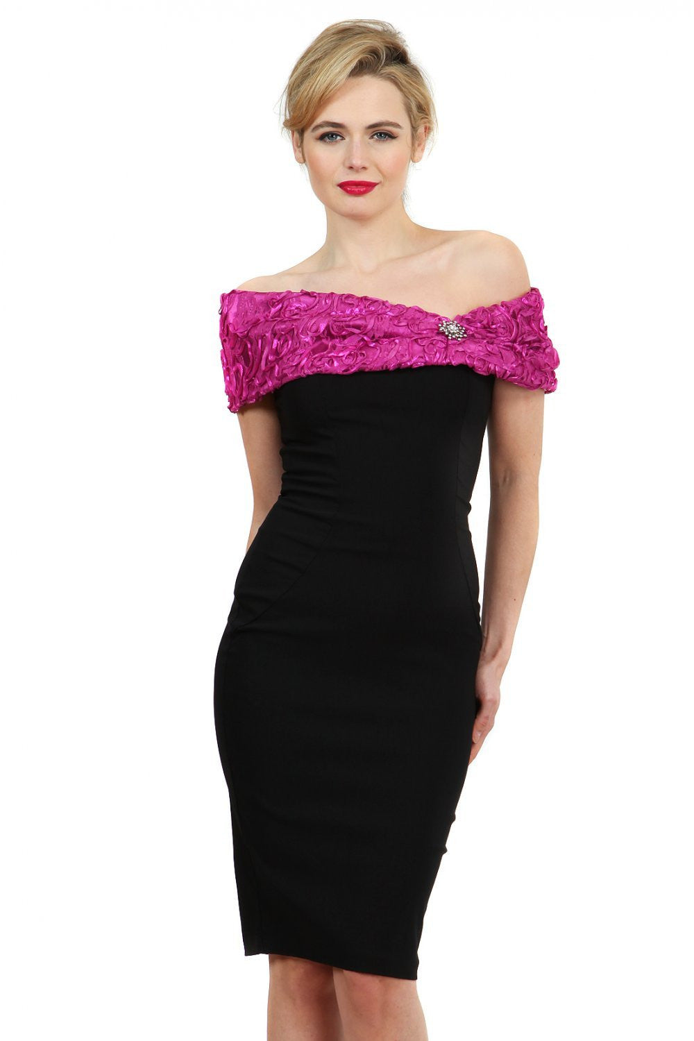 Model wearing the Diva Cornelli Perth dress with cornelli lace top, off shoulder design and diamanté brooch in black and fushia pink front image