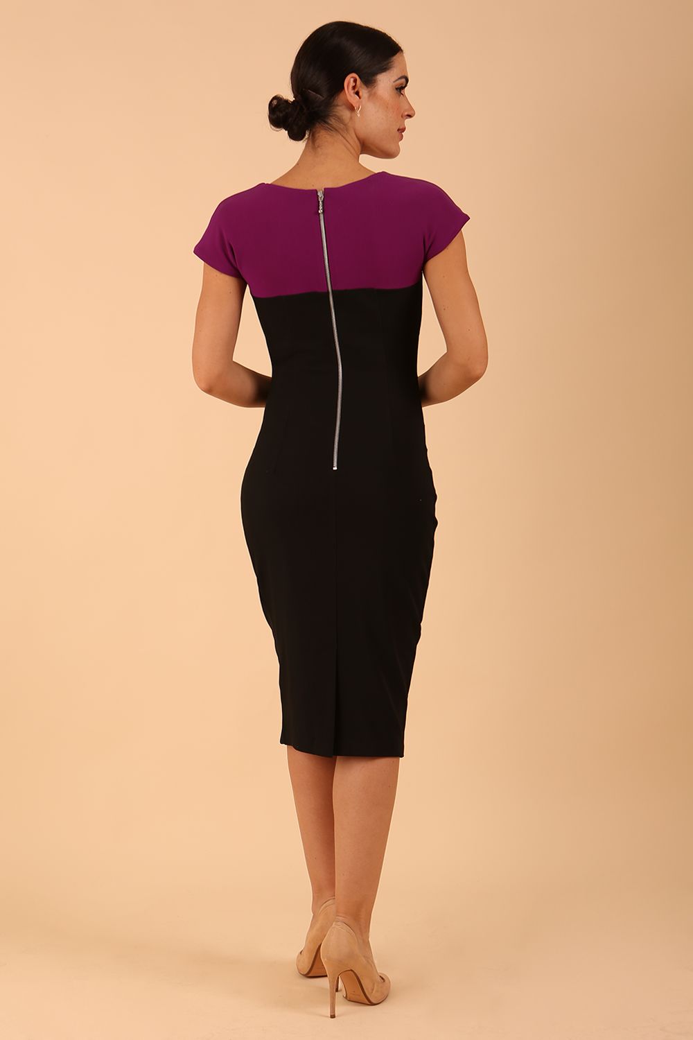 Model wearing the Diva Bryony Contrast dress with contrasting top and exposed zip at the back in black and violet purple front image