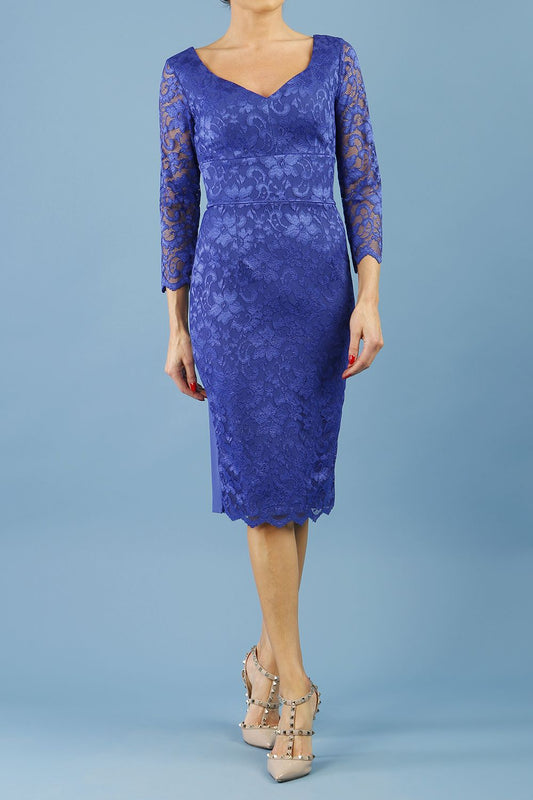 model is wearing diva catwalk bucklebury lace dress with sleeved and low neckline in riviera blue front