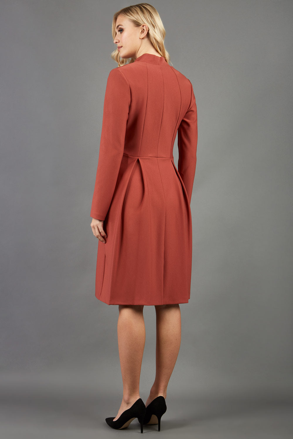 Blonde hair model wearing long sleeve bi stretch Taylor coat in Marsala Brown back image