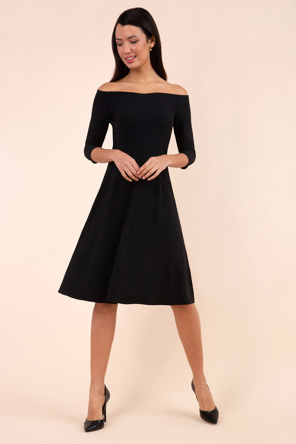 brunette model is wearing diva catwalk off shulder swing a-line islay dress with sleeves in black front