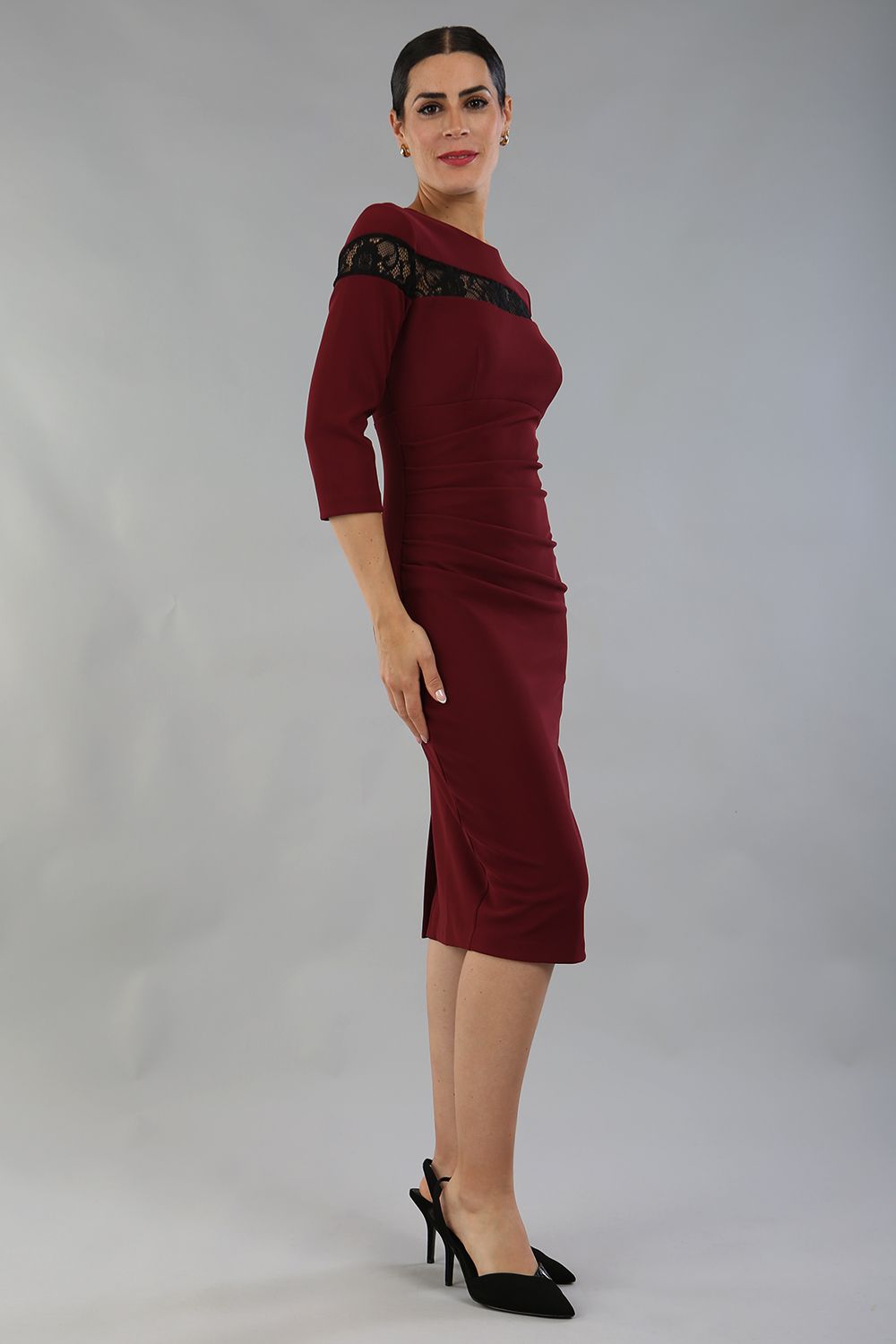 Model wearing the Diva Atlantis Pencil dress with three quarter length sleeves in cabaret burgundy and black side image