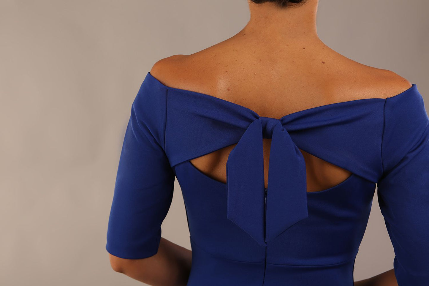 model wearing a diva catwalk Estonia Off shoulder Pencil Dress elbow length sleeve and knee length in Cobalt Blue colour back close up