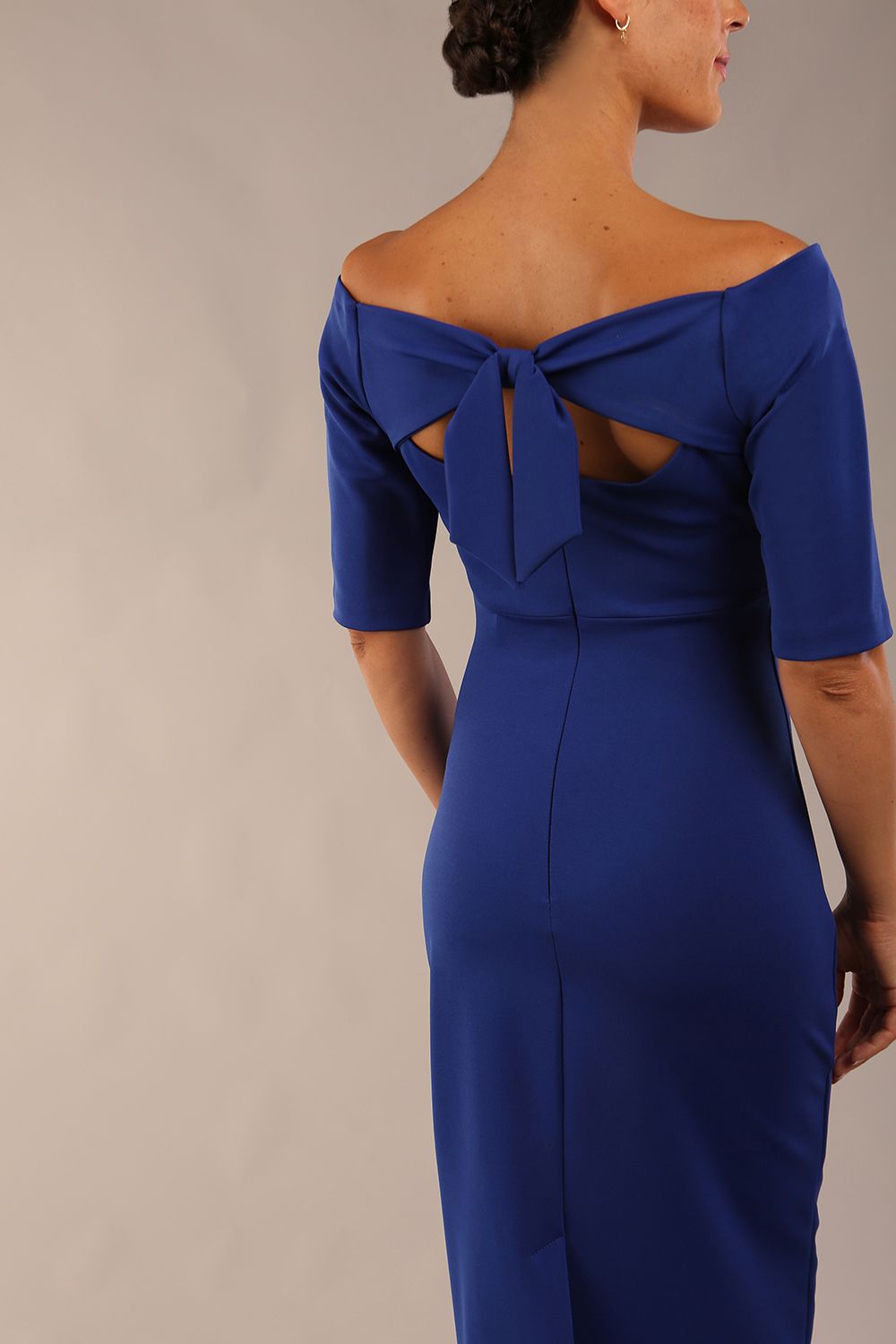 model wearing a diva catwalk Estonia Off shoulder Pencil Dress elbow length sleeve and knee length in Cobalt Blue colour back close up