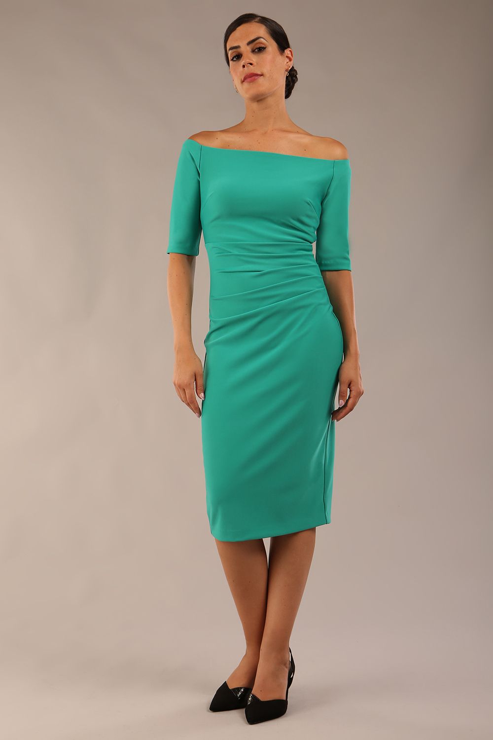 model wearing a diva catwalk Estonia Off shoulder Pencil Dress elbow length sleeve and knee length in Emerald Green colour