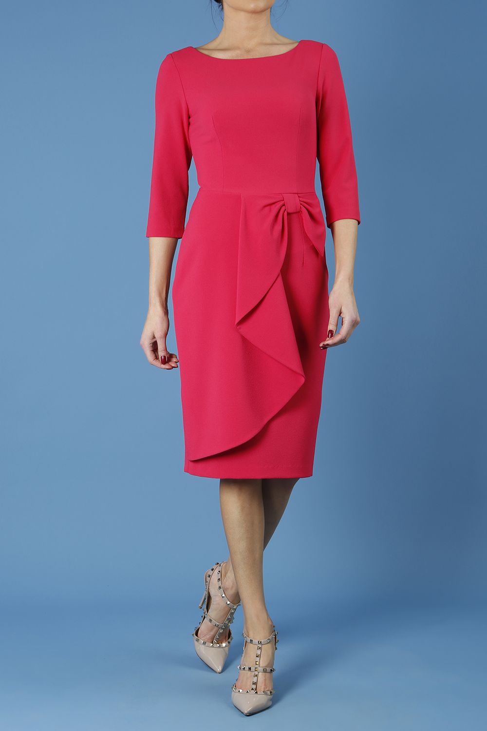 model is wearing diva catwalk jacky dress with rounded neckline 3/4 sleeve and bow detail on the waist in honeysuckle pink front 