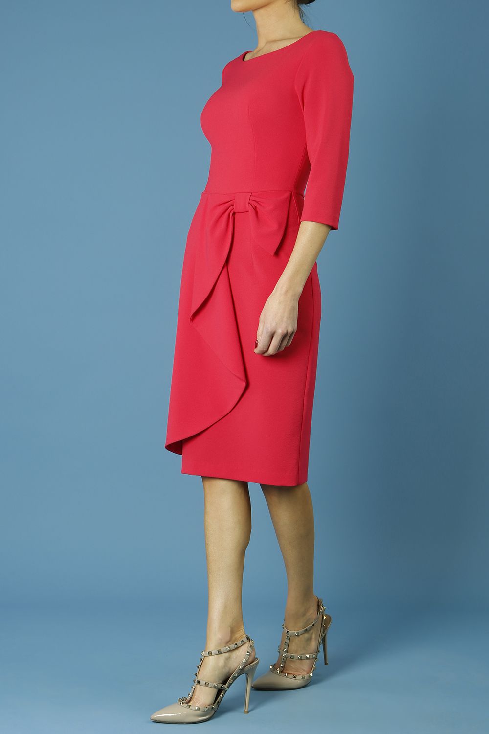 model is wearing diva catwalk jacky dress with rounded neckline 3/4 sleeve and bow detail on the waist in honeysuckle pink front 