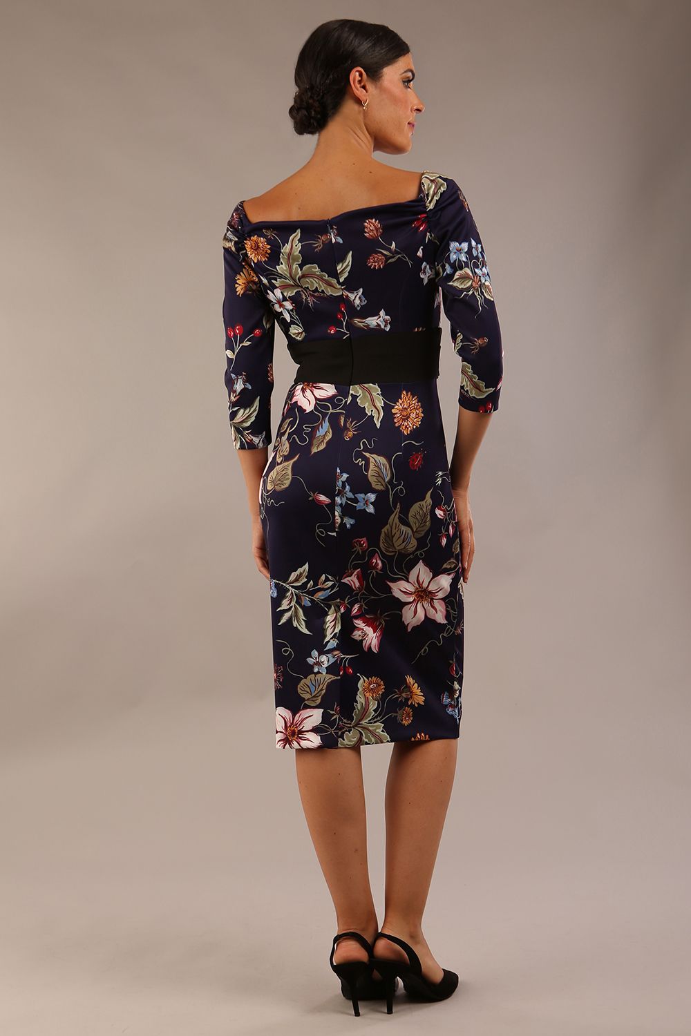 model wears Alpa Print off the shoulder pencil sheath Dress with long sleeves back image in wildflower print