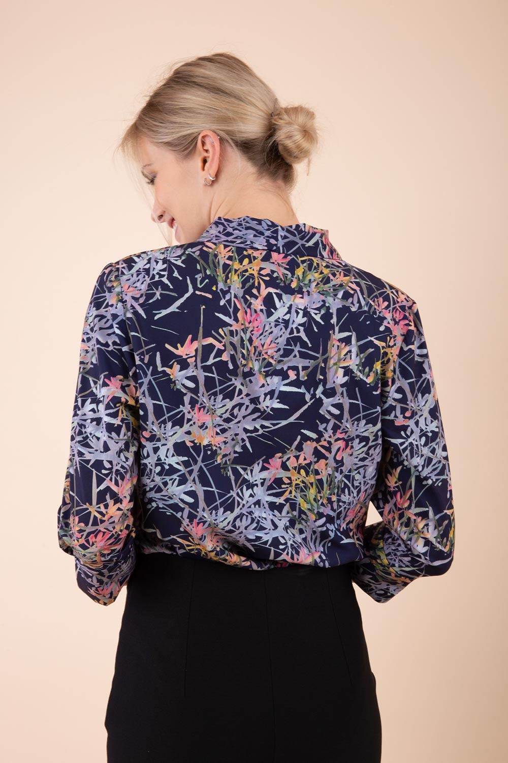 Model wearing the Diva floral top in navy blue back image