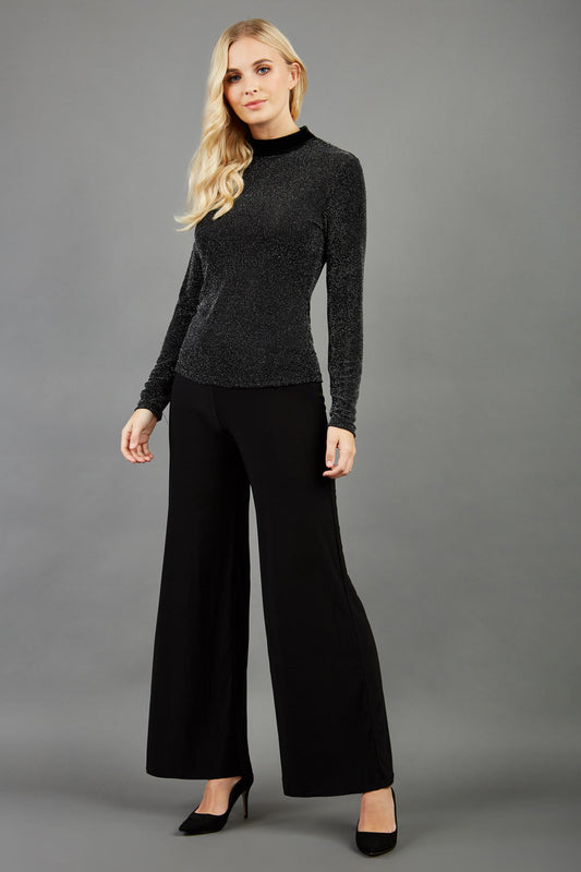 Blonde hair model is wearing a jersey sparkle velvet turtleneck blouse top  front image