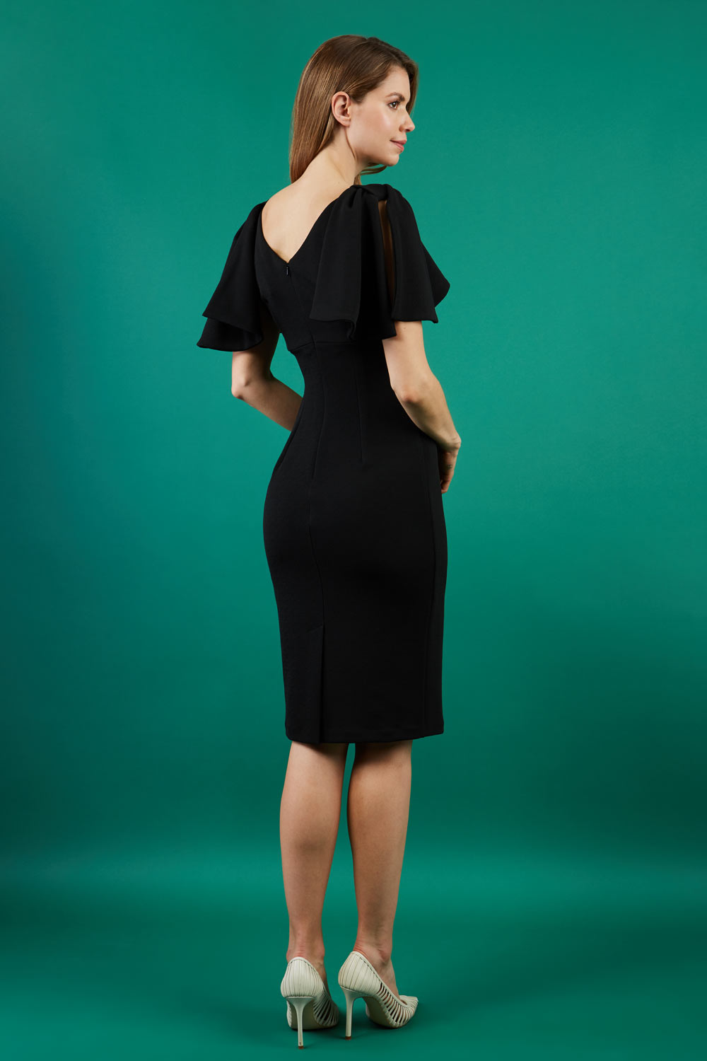 brunette model is wearing diva catwalk hermione pencil dress with tie shoulder details and empire waistline in black back