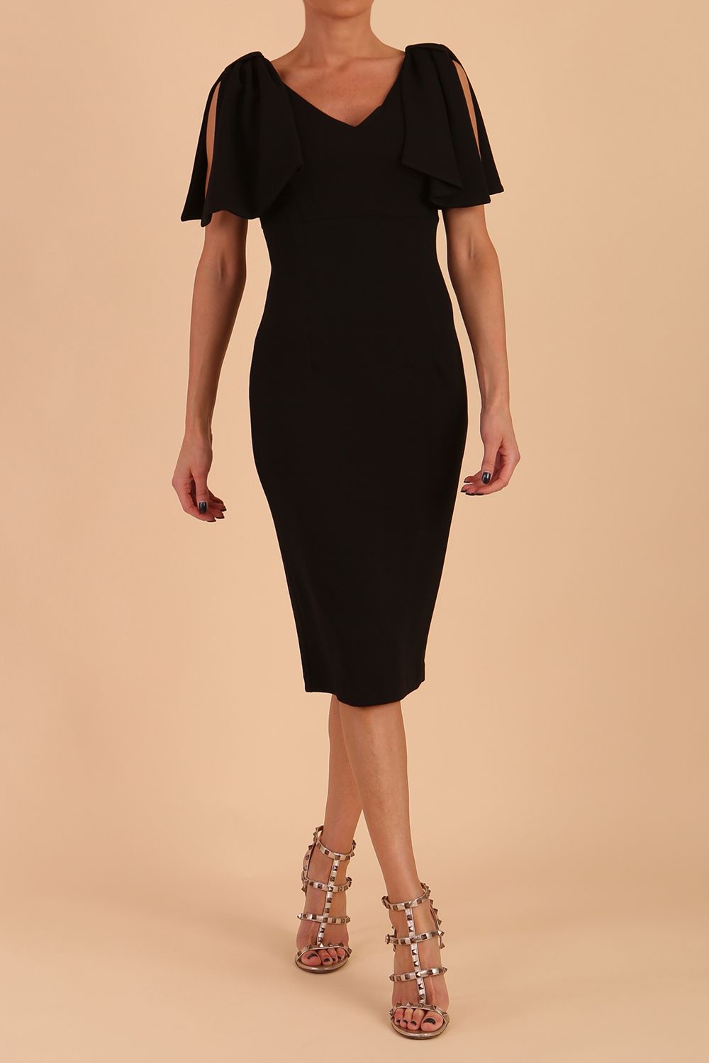 brunette model is wearing diva catwalk hermione pencil dress with tie shoulder details and empire waistline in black front