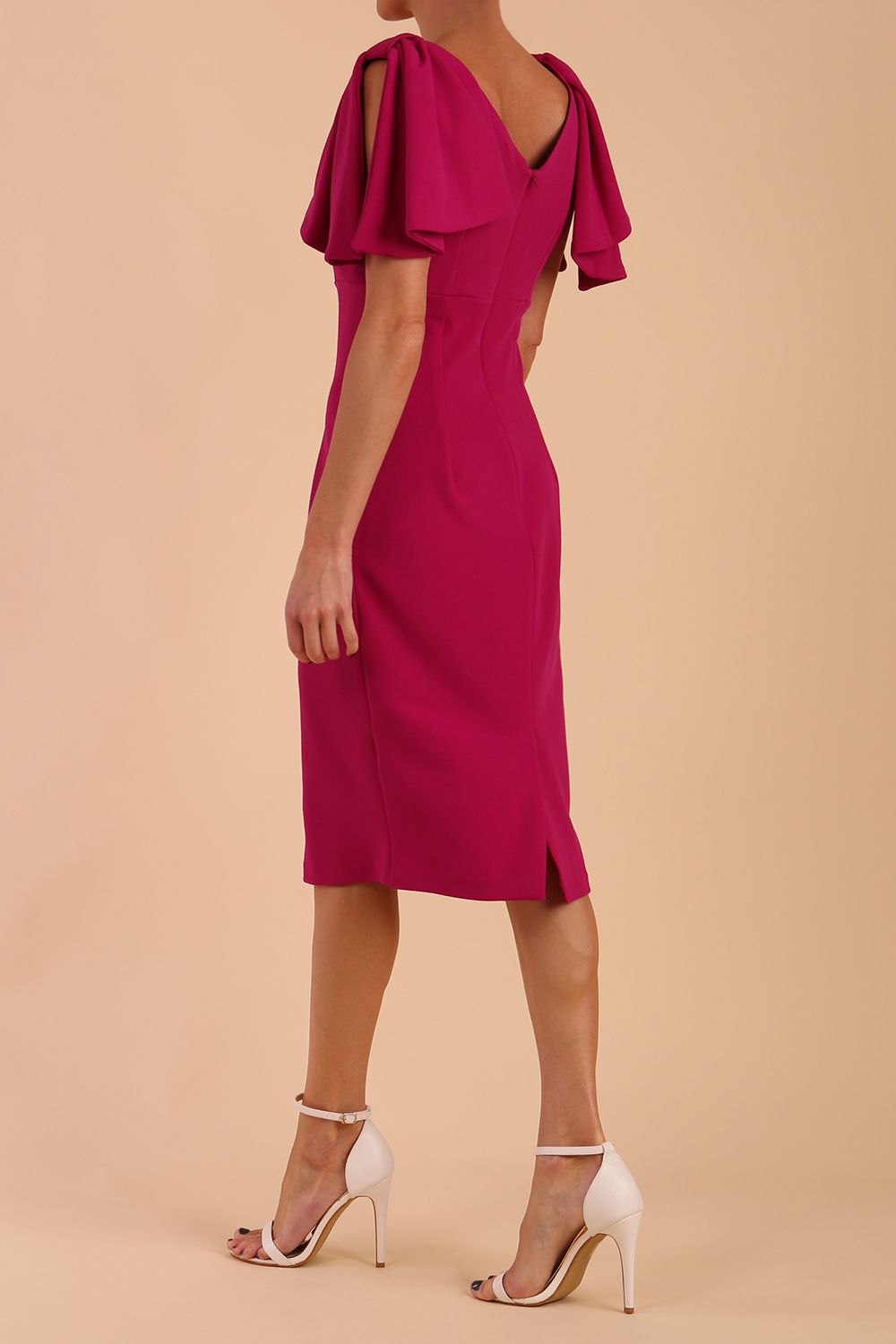 brunette model is wearing diva catwalk hermione pencil dress with tie shoulder details and empire waistline in magenta haze back