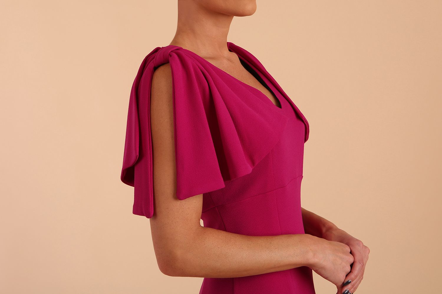 brunette model is wearing diva catwalk hermione pencil dress with tie shoulder details and empire waistline in magenta haze shoulders detail