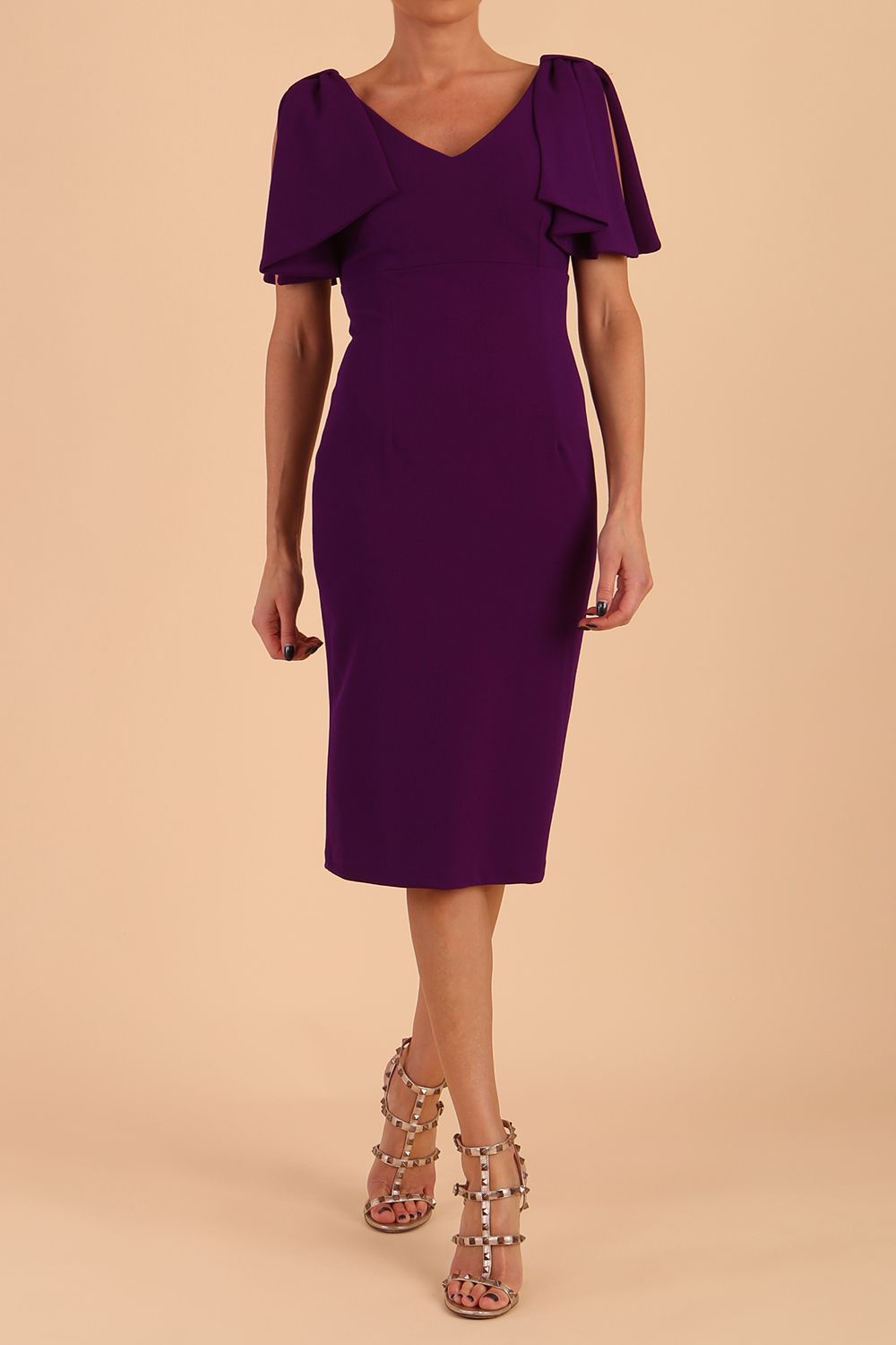 brunette model is wearing diva catwalk hermione pencil dress with tie shoulder details and empire waistline in Deep Purple front