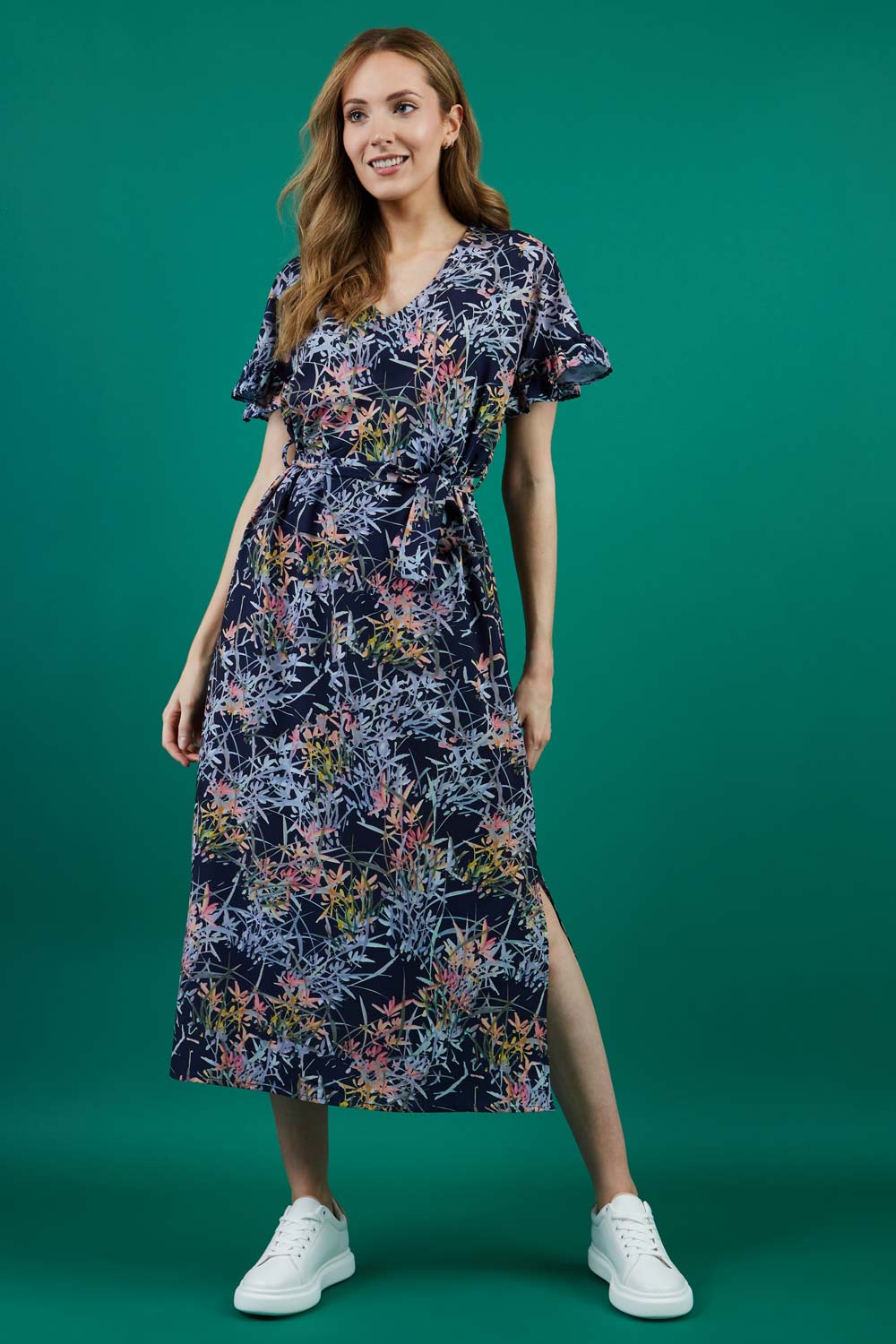 brunette model is wearing diva catwalk carella short sleeve printed midi dress with a belt in navy floral print front