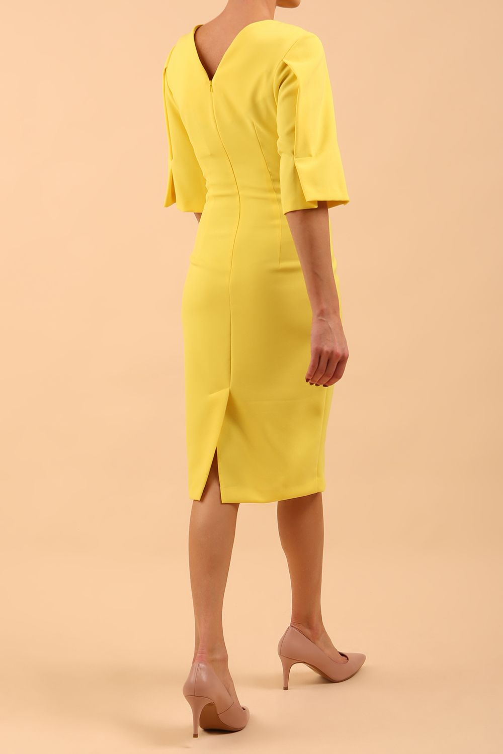 model is wearing divacatwalk chiswick pencil dress rounded neck with short sleeve in blazing yellow back