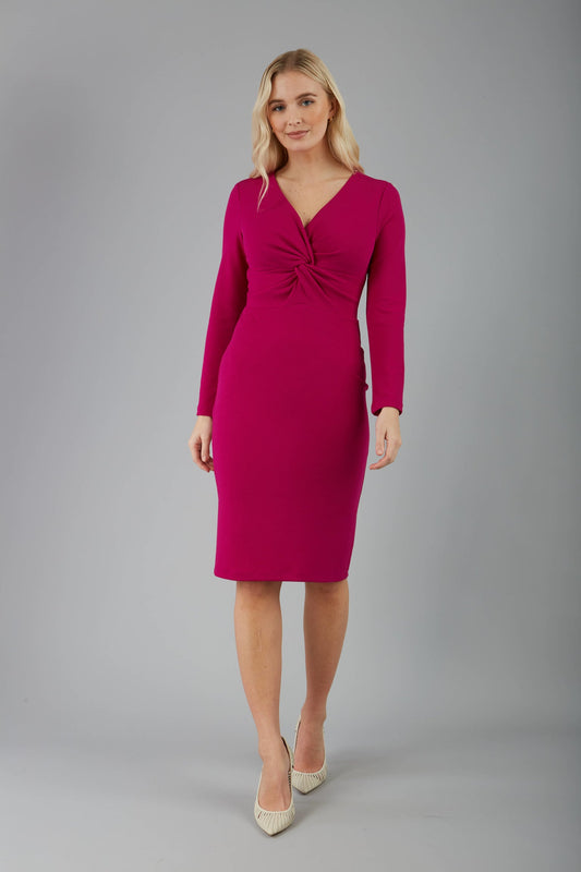 blonde model is wearing diva catwalk gately pencil dress with long sleeves and twisted low v-neck in magenta front