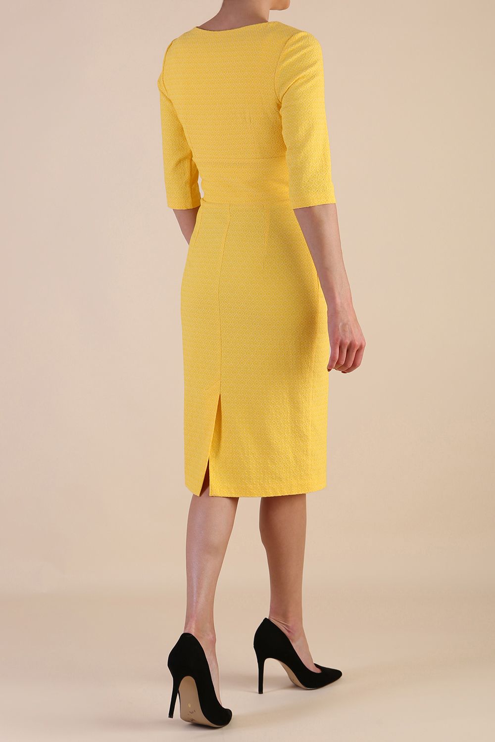 Model wearing diva catwalk Harriet Elbow Sleeve Knee Lenght Jacquard Dress in Lemon colour back