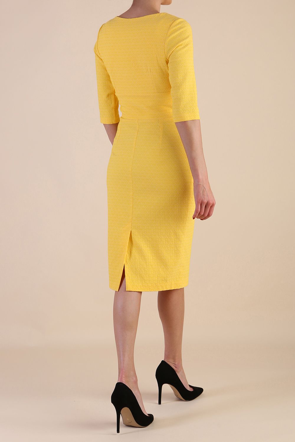 Model wearing diva catwalk Harriet Elbow Sleeve Knee Lenght Jacquard Dress in Lemon colour back