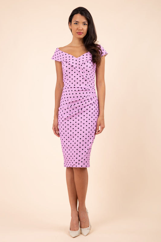 Brunette model wearing Diva Catwalk Fenella Polka Dot Pencil Sleeveless Dress off shoulder bardot neckline in pink front