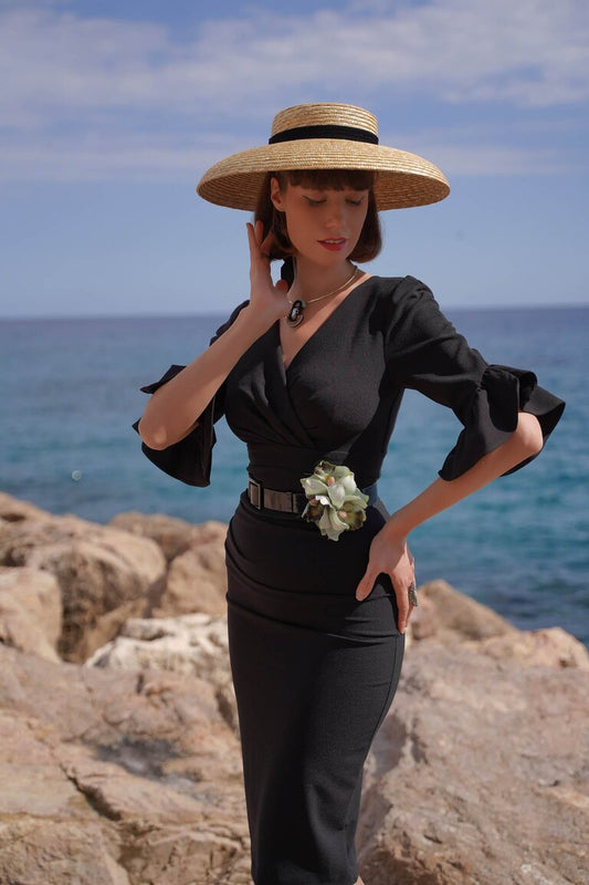 brunette model is wearing diva catwalk hollie pencil dress with frilled flute sleeve and low v-neck cut in black front